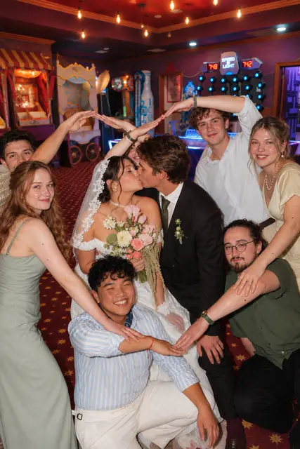 The newlyweds celebrating with friends in the carnival room
