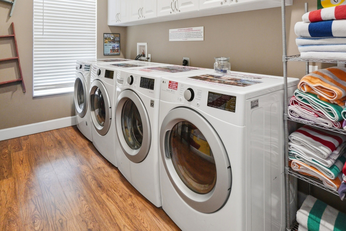 Convenient laundry room with 2 washers and 2 dryers.