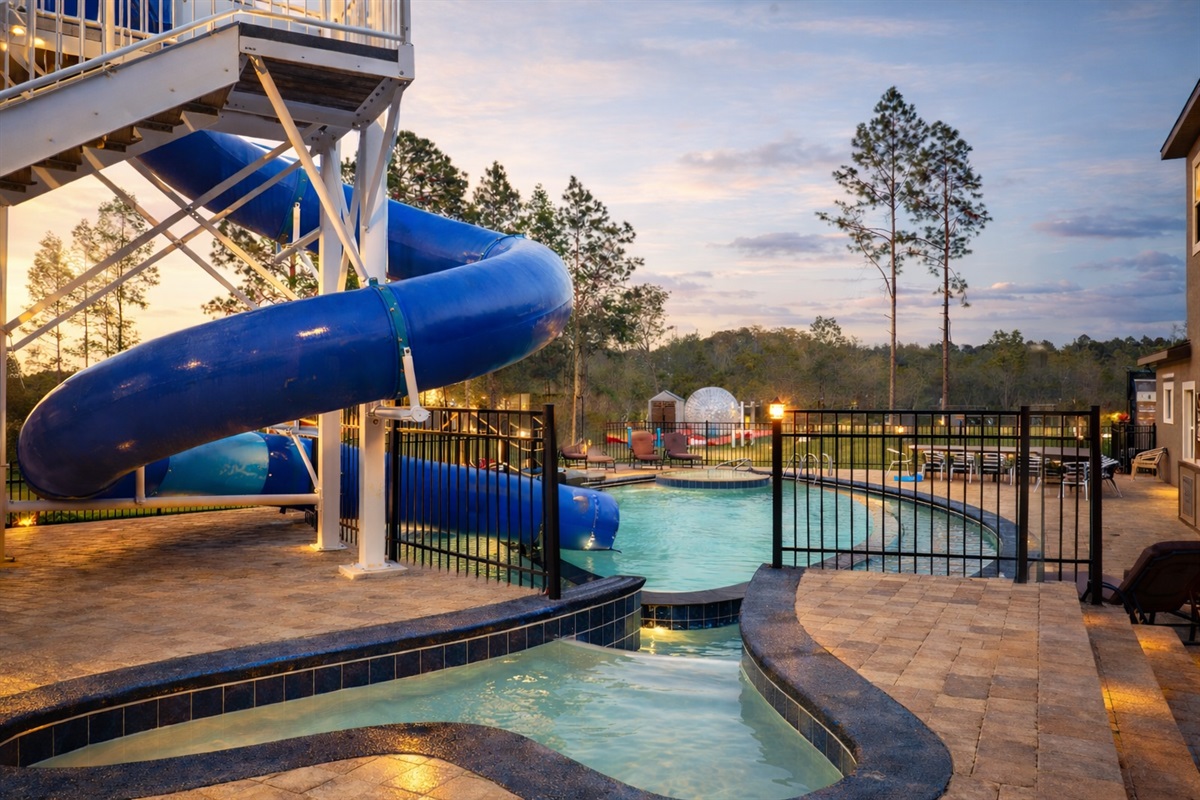 The pool and waterslide at dusk.