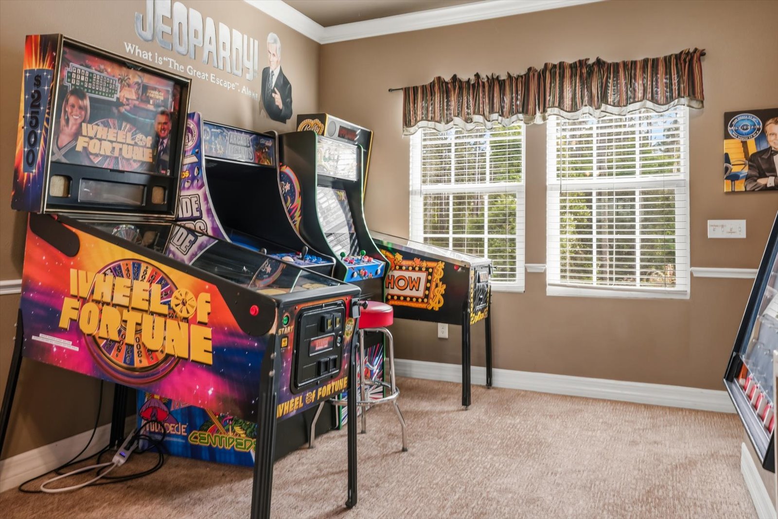 Wheel of Fortune pinball beside the classic cabinets